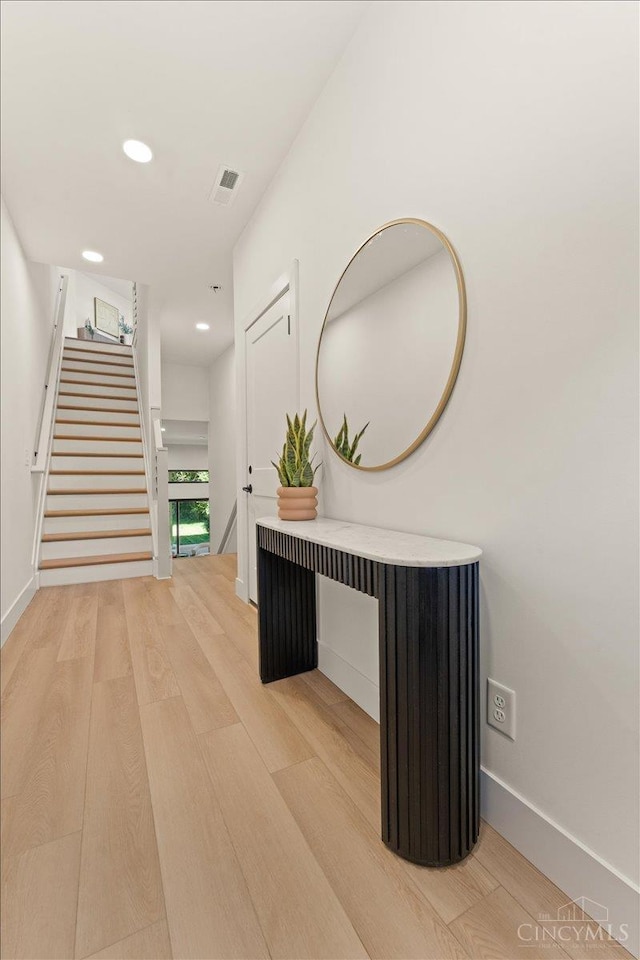 963 Windsor St, Cincinnati, OH 45206 - hall featuring light wood-type flooring, stairs, and recessed lighting