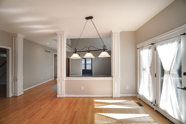 1031 Westchester, Union Twp, OH 45244 - unfurnished dining area featuring ornate columns and light wood-type flooring