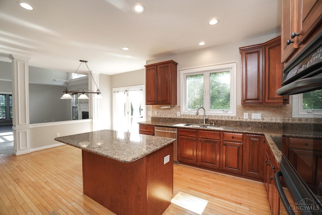 1031 Westchester, Union Twp, OH 45244 - kitchen with dishwasher, backsplash, a center island, wainscoting, and plenty of natural light