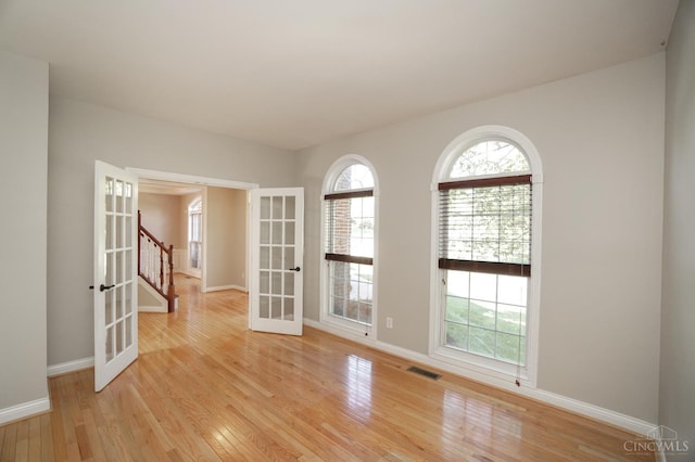 1031 Westchester, Union Twp, OH 45244 - spare room featuring french doors, light wood finished floors, and stairs