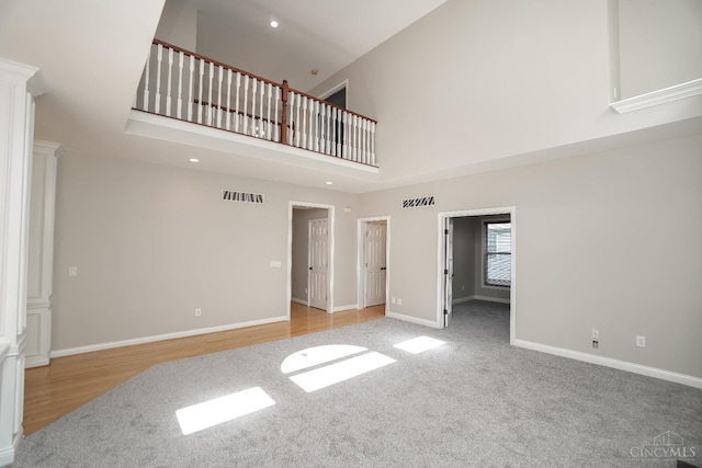 1031 Westchester, Union Twp, OH 45244 - unfurnished living room featuring a towering ceiling, carpet floors, decorative columns, and recessed lighting