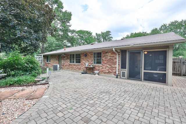 6341 Marshall Rd, Centerville, OH 45459 - back of property with a sunroom, brick siding, and a patio