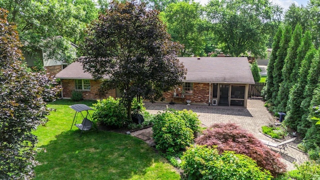 6341 Marshall Rd, Centerville, OH 45459 - back of house with a sunroom, a yard, brick siding, and a patio area