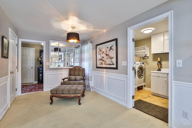 6341 Marshall Rd, Centerville, OH 45459 - sitting room with washing machine and clothes dryer, light carpet, a decorative wall, and wainscoting
