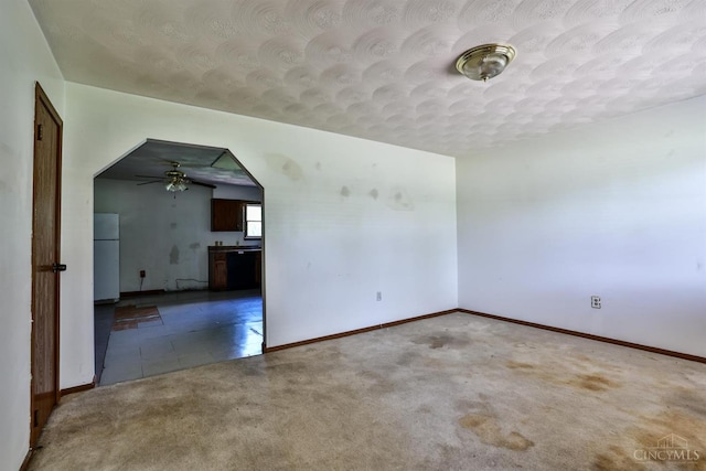17403 Bloomrose Rd, Sterling Twp, OH 45176 - empty room featuring carpet flooring, ceiling fan, a textured ceiling, and arched walkways
