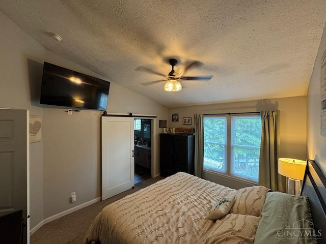 8091 Celestial Cir, Liberty Twp, OH 45044 - bedroom with vaulted ceiling, a barn door, a textured ceiling, dark colored carpet, and ceiling fan