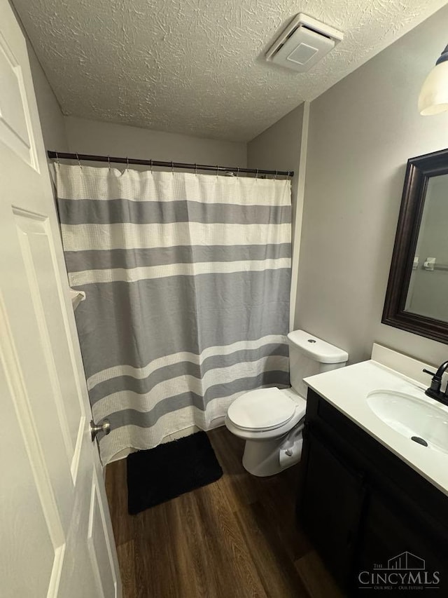 8091 Celestial Cir, Liberty Twp, OH 45044 - bathroom with wood finished floors, vanity, a textured ceiling, and curtained shower