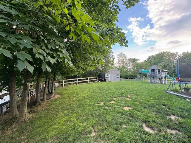 8091 Celestial Cir, Liberty Twp, OH 45044 - fenced backyard with a trampoline, a playground, and a storage shed