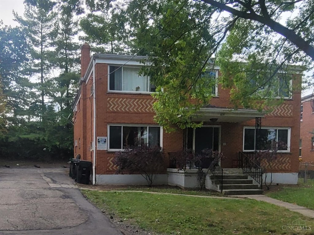 5859 Shadymist Ln, Cincinnati, OH 45239 - multi unit property with a porch, brick siding, a chimney, and a front lawn