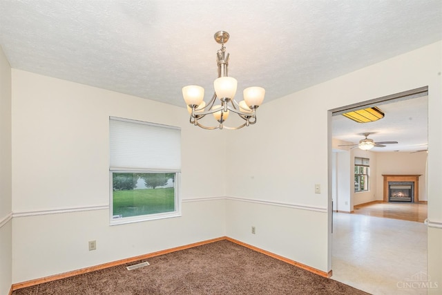 6409 Stapleton Ct, Fairfield Twp, OH 45011 - spare room with a chandelier and a warm lit fireplace