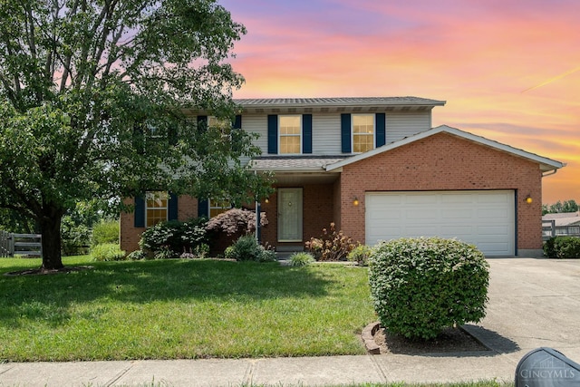 6409 Stapleton Ct, Fairfield Twp, OH 45011 - traditional-style house with a garage, driveway, a front lawn, and brick siding