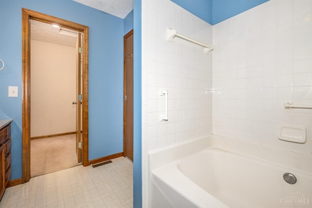6409 Stapleton Ct, Fairfield Twp, OH 45011 - bathroom featuring vanity, tile patterned floors, and washtub / shower combination