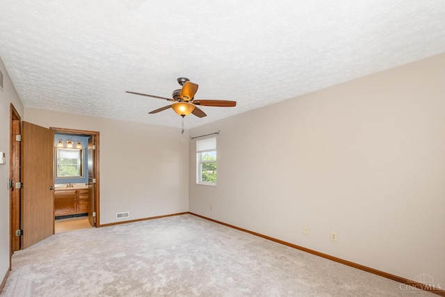 6409 Stapleton Ct, Fairfield Twp, OH 45011 - unfurnished room with a ceiling fan, light colored carpet, and a textured ceiling