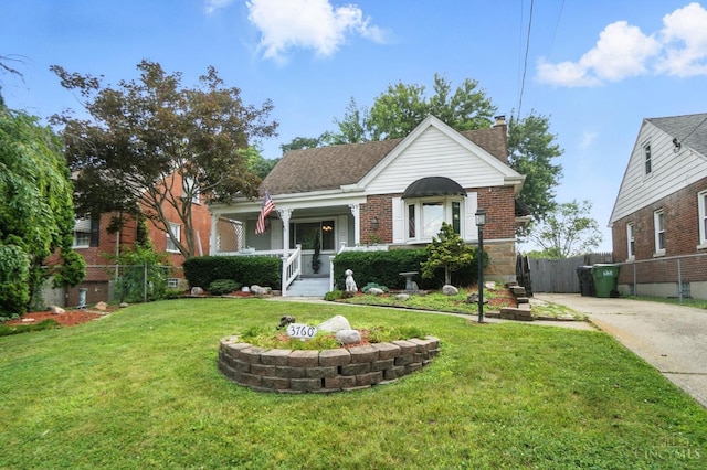 3760 Feldkamp Ave, Green Twp, OH 45211 - bungalow-style house featuring a chimney, concrete driveway, brick siding, and a porch