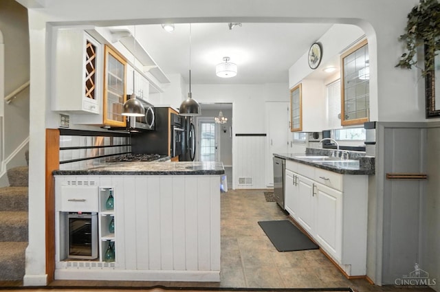 3760 Feldkamp Ave, Green Twp, OH 45211 - kitchen with appliances with stainless steel finishes, beverage cooler, white cabinets, and dark stone counters