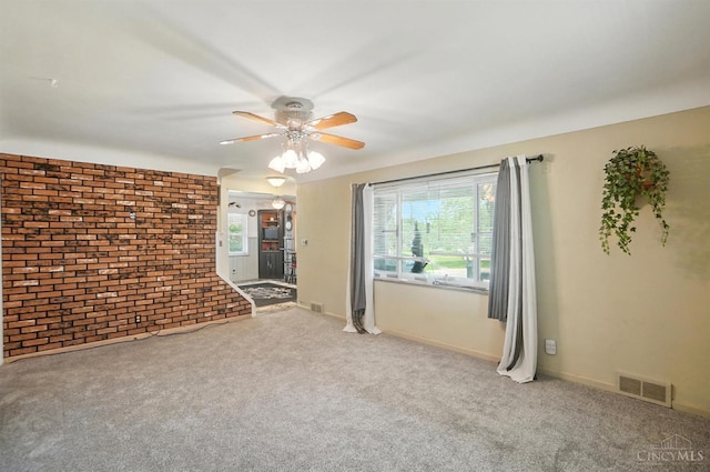 3760 Feldkamp Ave, Green Twp, OH 45211 - carpeted spare room featuring brick wall, plenty of natural light, and ceiling fan
