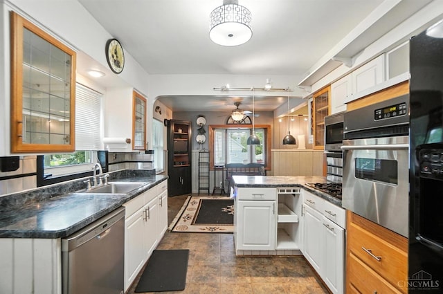 3760 Feldkamp Ave, Green Twp, OH 45211 - kitchen featuring appliances with stainless steel finishes, a peninsula, white cabinetry, dark countertops, and glass insert cabinets