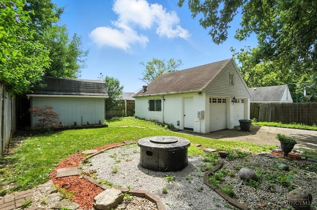 3760 Feldkamp Ave, Green Twp, OH 45211 - fenced backyard featuring an outdoor structure, a detached garage, and a fire pit