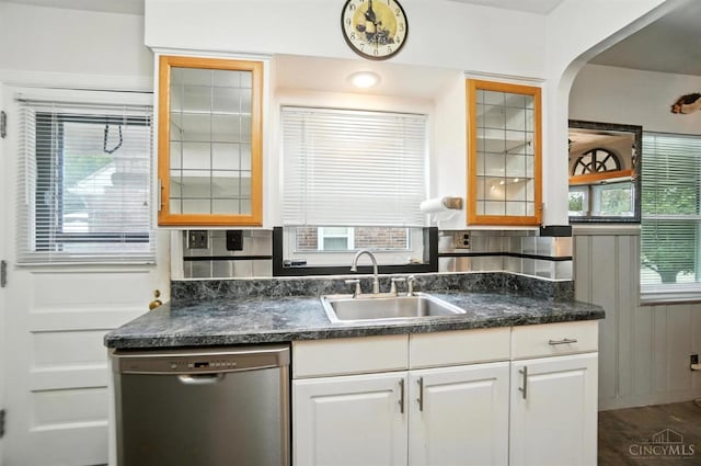 3760 Feldkamp Ave, Green Twp, OH 45211 - kitchen featuring dishwasher, white cabinetry, dark countertops, glass insert cabinets, and arched walkways