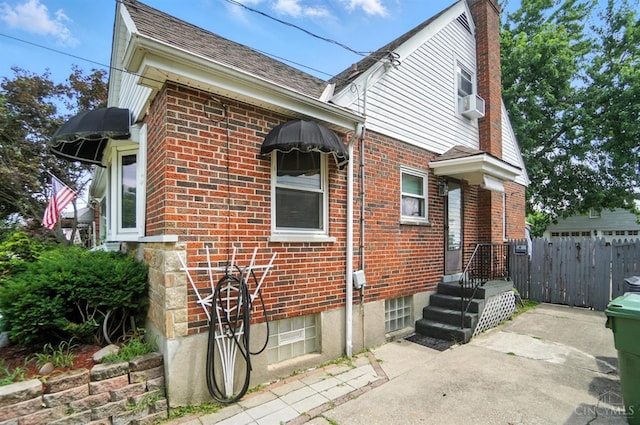 3760 Feldkamp Ave, Green Twp, OH 45211 - view of side of property with brick siding, a chimney, and a shingled roof