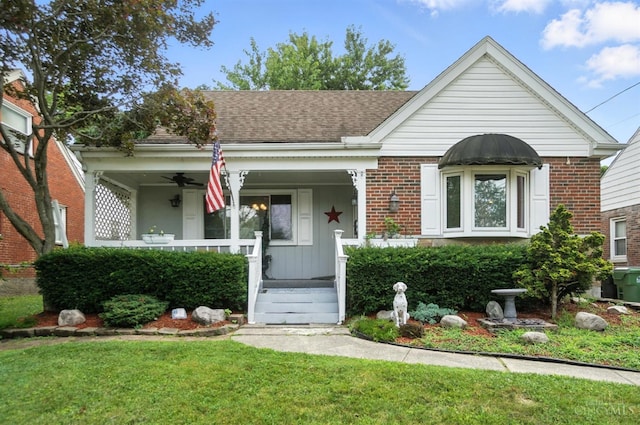 3760 Feldkamp Ave, Green Twp, OH 45211 - bungalow-style home with covered porch, brick siding, a front lawn, and roof with shingles