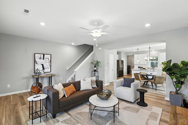 1545 Ruth Ave, Cincinnati, OH 45207 - living area featuring stairway, light wood-style floors, recessed lighting, and ceiling fan