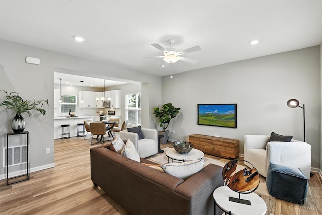 1545 Ruth Ave, Cincinnati, OH 45207 - living area featuring light wood-type flooring, ceiling fan, and recessed lighting