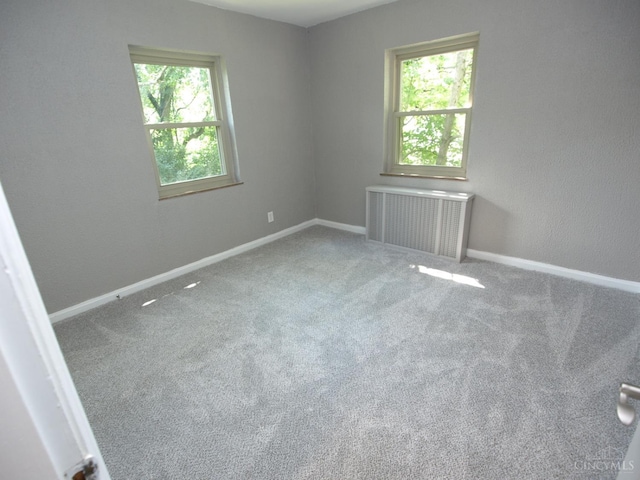 3527 Reemelin Rd, Green Twp, OH 45211 - carpeted empty room featuring radiator heating unit and healthy amount of natural light