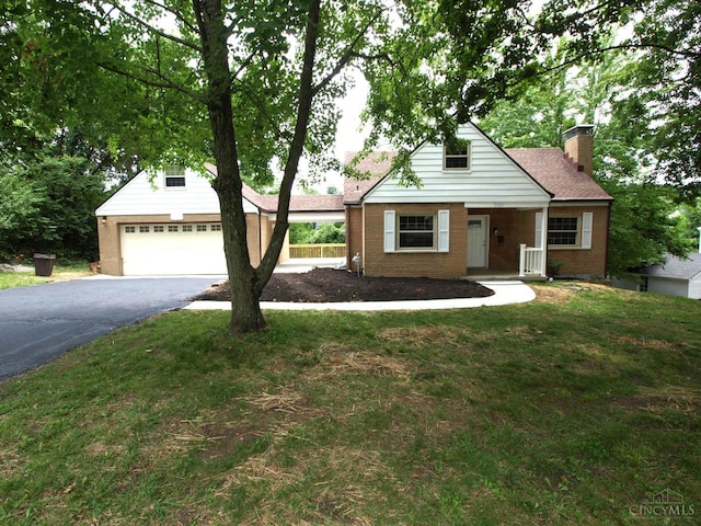 3527 Reemelin Rd, Green Twp, OH 45211 - view of front facade with driveway, a chimney, brick siding, and a front lawn