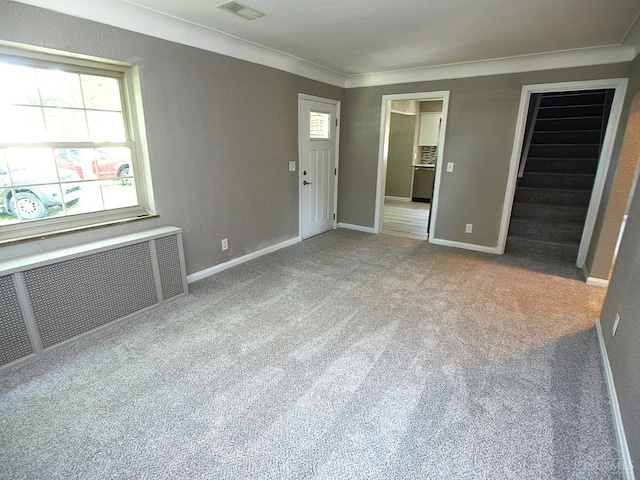 3527 Reemelin Rd, Green Twp, OH 45211 - carpeted spare room featuring radiator heating unit and ornamental molding
