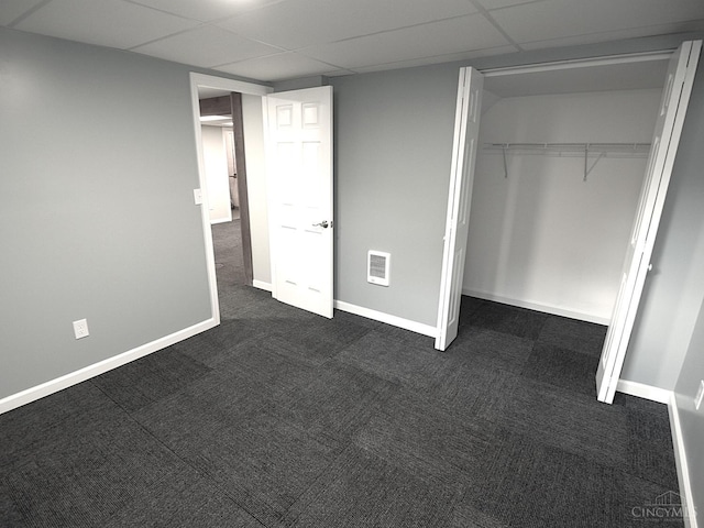 3527 Reemelin Rd, Green Twp, OH 45211 - unfurnished bedroom with dark carpet, a closet, and a drop ceiling