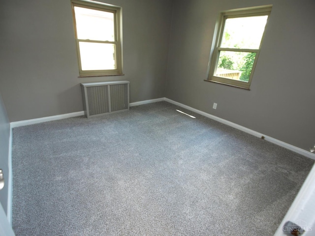 3527 Reemelin Rd, Green Twp, OH 45211 - spare room with radiator, plenty of natural light, and carpet flooring