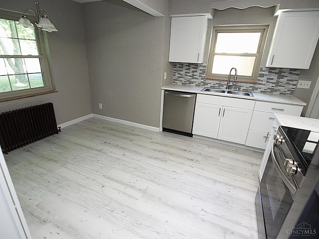 3527 Reemelin Rd, Green Twp, OH 45211 - kitchen with appliances with stainless steel finishes, light countertops, tasteful backsplash, and white cabinets