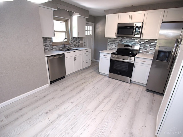 3527 Reemelin Rd, Green Twp, OH 45211 - kitchen featuring appliances with stainless steel finishes, backsplash, light wood finished floors, and light countertops