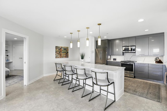 1201 Edgecliff Pl Unit 1083, Cincinnati, OH 45206 - kitchen featuring stainless steel appliances, gray cabinetry, a breakfast bar, recessed lighting, and light stone counters