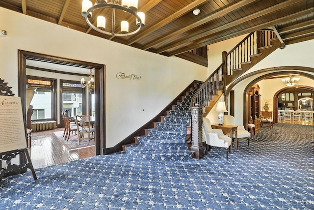 1201 Edgecliff Pl Unit 1083, Cincinnati, OH 45206 - stairway with a chandelier, arched walkways, radiator, and a wood ceiling with exposed beams