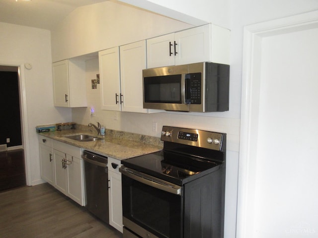 8608 Long Ln, Springfield Twp, OH 45231 - kitchen with stainless steel appliances, white cabinetry, dark wood-style flooring, and vaulted ceiling