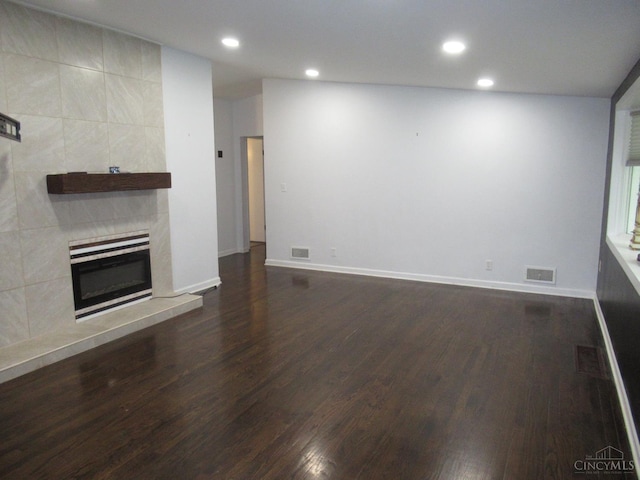 8608 Long Ln, Springfield Twp, OH 45231 - unfurnished living room with dark wood-style flooring, recessed lighting, and a tiled fireplace
