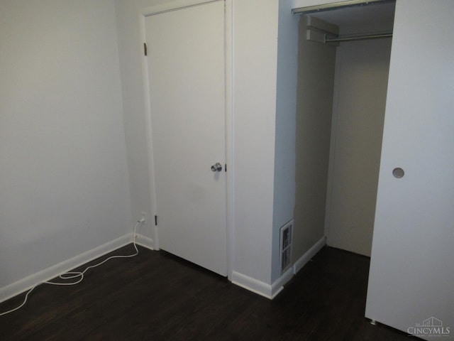 8608 Long Ln, Springfield Twp, OH 45231 - unfurnished bedroom featuring dark wood-type flooring and baseboards