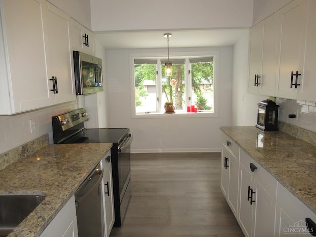 8608 Long Ln, Springfield Twp, OH 45231 - kitchen featuring stainless steel appliances, wood finished floors, tasteful backsplash, white cabinets, and light stone counters