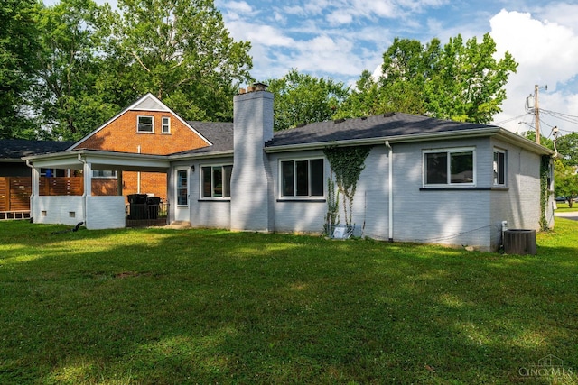 6537 Craigland Ct, Cincinnati, OH 45230 - rear view of house featuring a chimney, a lawn, and brick siding