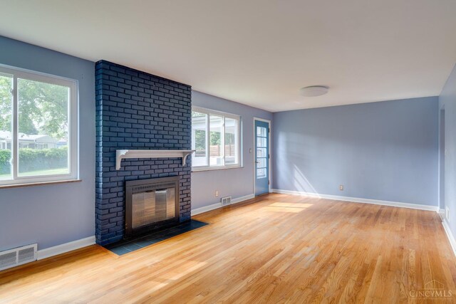 6537 Craigland Ct, Cincinnati, OH 45230 - unfurnished living room featuring wood finished floors and a brick fireplace
