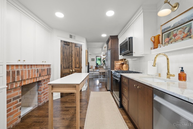 1236 Louden St, Cincinnati, OH 45202 - kitchen with stainless steel appliances, decorative backsplash, dark wood-type flooring, white cabinets, and recessed lighting