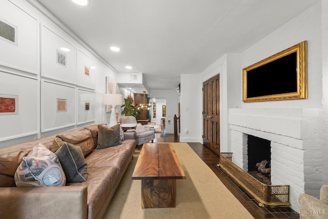 1236 Louden St, Cincinnati, OH 45202 - living room featuring a brick fireplace, recessed lighting, and dark wood-type flooring