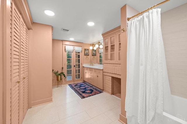 1236 Louden St, Cincinnati, OH 45202 - bathroom featuring vanity, a closet, shower / tub combo, recessed lighting, and tile patterned flooring
