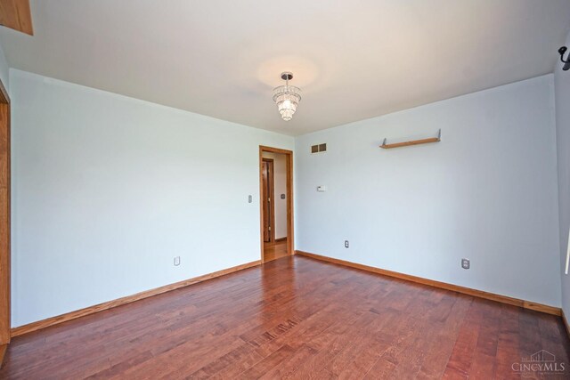 8424 Oak Grove Rd, Georgetown, OH 45121 - unfurnished room featuring wood finished floors and a chandelier