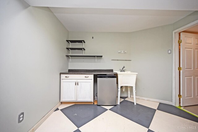8424 Oak Grove Rd, Georgetown, OH 45121 - kitchen featuring light floors, dishwasher, open shelves, and dark countertops