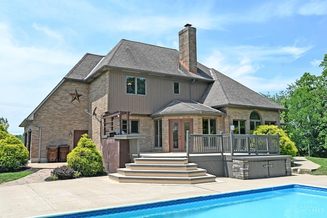 8424 Oak Grove Rd, Georgetown, OH 45121 - rear view of property with a chimney, brick siding, an outdoor pool, and a shingled roof