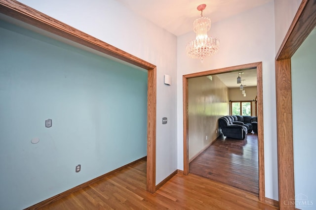 8424 Oak Grove Rd, Georgetown, OH 45121 - corridor featuring wood finished floors and a chandelier