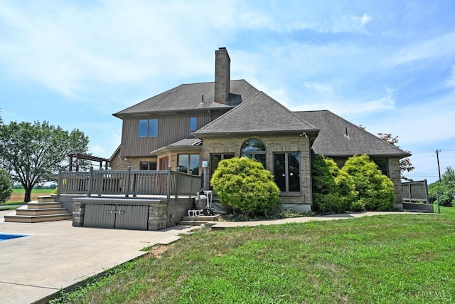 8424 Oak Grove Rd, Georgetown, OH 45121 - rear view of house featuring brick siding, a deck, a lawn, and a shingled roof